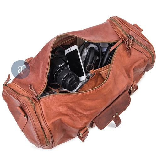 Top View Of The Expedition Duffle Showing Its Spacious Interior With Camera, Phone, And Headphones Inside